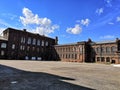 Old red brick building blue sky and clouds Old red brick building with Windows reflecting the light. architecture.Old architecture Royalty Free Stock Photo