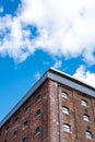 Old red brick building or factory with many small windows Royalty Free Stock Photo