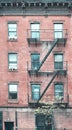 Old red brick building with fire escapes, color toning applied, New York City, USA Royalty Free Stock Photo