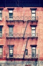 Old red brick building with fire escapes, New York City. Royalty Free Stock Photo