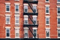 Old red brick building with fire escapes, New York City. Royalty Free Stock Photo