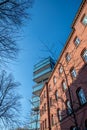 Old red brick building in front of architectural modern office building and blue sky Royalty Free Stock Photo