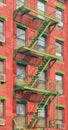 Old red brick building with green iron fire escape, New York City, USA Royalty Free Stock Photo