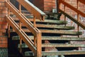 Old red brick building stairs with wooden railing Royalty Free Stock Photo