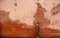 Old red brick building wall with broken plaster Royalty Free Stock Photo