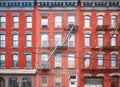 Old red brick buildings with blue iron fire escapes, New York City, USA