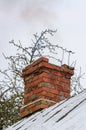 An old red brick chimney crowns the slate roof Royalty Free Stock Photo