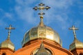 Old red brick Christian church with gold and gilded domes against a blue sky. Concept faith in god, orthodoxy, prayer Royalty Free Stock Photo