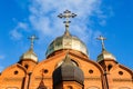 Old red brick Christian church with gold and gilded domes against a blue sky. Concept faith in god, orthodoxy, prayer Royalty Free Stock Photo