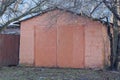 old red brick garage with closed iron gates