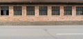 Red brick industrial building with large windows Royalty Free Stock Photo