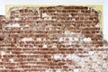 Old red brick laying on the background of a restored wall