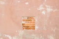 Old red brick and painted plaster wall with cracked shabby surface texture background. Royalty Free Stock Photo