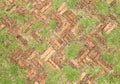 Old red brick paving stones with grass growing along Royalty Free Stock Photo