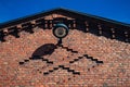 An old red brick rail yard building wall with an old lamp