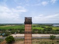 Old red brick smokestack and rice farms background Royalty Free Stock Photo