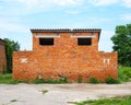 Old red brick toilet on the street on a summer day. Royalty Free Stock Photo