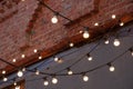Old red brick wall with bulb lights lamp Royalty Free Stock Photo