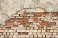 Old Red Brick wall with damaged grey plaster background