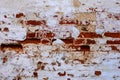 An old red brick wall with fallen off white plaster. Royalty Free Stock Photo