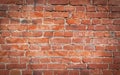 Old red brick wall grunge texture. Old cracked bricks wall with a weathered surface with with vignetted corners Royalty Free Stock Photo