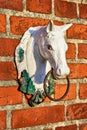 Old red brick wall with horse-head sculpture Royalty Free Stock Photo