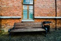 Old red brick wall and old wood window and wood bench background vintage tone. Royalty Free Stock Photo