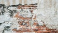 Old red brick wall with peeled white beige stucco Royalty Free Stock Photo