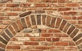 Old red brick wall texture with arch. Royalty Free Stock Photo