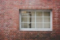 Old red brick wall texture background with classic white wooden frame and sash window with glass panels, copy space Royalty Free Stock Photo