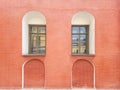 An old red brick wall and two green windows on it Royalty Free Stock Photo