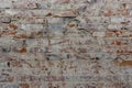 Old red bricks of dirty wall background with broken white coating Royalty Free Stock Photo
