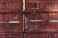 Old red brown wooden door with metal handle garage antique balkan aged with rusted metal bars in Sofia, Bulgaria Royalty Free Stock Photo