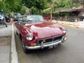 Old red burgundy sport 1970s MG MGB roadster parked in the street. Classic car show. Royalty Free Stock Photo