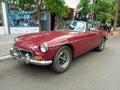 Old red burgundy sport 1970s MG MGB roadster parked in the street. Classic car show. Royalty Free Stock Photo