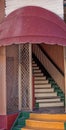 Old Red Canvas Canopy Opening To Stairway