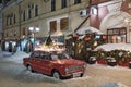 Old red car of Zhiguli model, decorated for winter holidays.