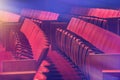 Old red chairs at the empty theatre