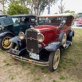 Old red 1931 Chevrolet Chevy Phaeton four door by GM in a park. AAA 2022 classic car show