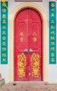 Old red chinese temple door with crave leaf