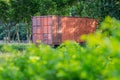 Old red container in the middle of the green park. Royalty Free Stock Photo