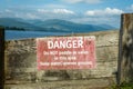 An old red Danger, Do not paddle or swim warning sign at Loch Lomond, Scotland