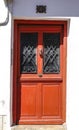 Old red door with black wrought details