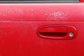 Old red door handle car. Weather-induced variations on the car door Royalty Free Stock Photo