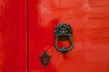 Old red door with lion head metal knockers