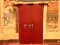 Ancient mural wall painting and red door at Phumin temple