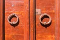Old red door with round metal handles. Orte, Italy Royalty Free Stock Photo