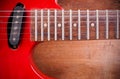 The old red electric guitar that is placed on a wooden floor. Royalty Free Stock Photo
