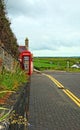 Old Red English Telephone booth at Giants Causeway UNESCO site Royalty Free Stock Photo