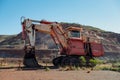 Old red excavator in Tom Price iron ore mine in Pilbara region at tourist tour